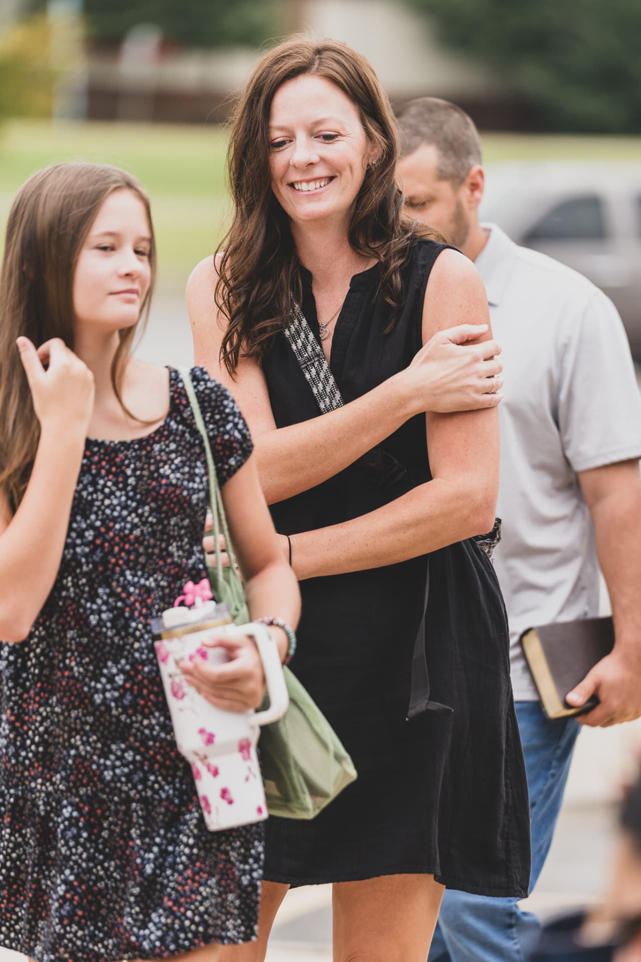 A mom walking into church with her daughter